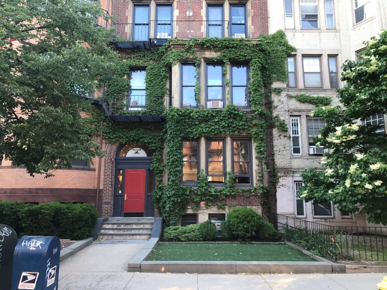 The 526 Beacon Street brownstone, ivy-covered facade with a red front door.