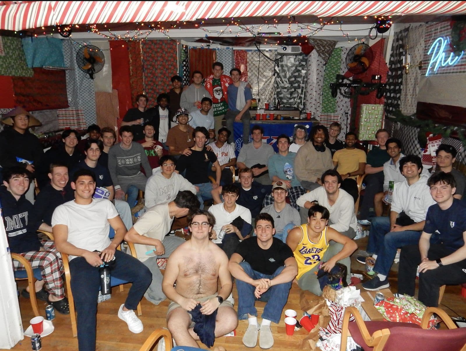 The house packed into a common room decorated in wrapping paper for the Christmas Roast.