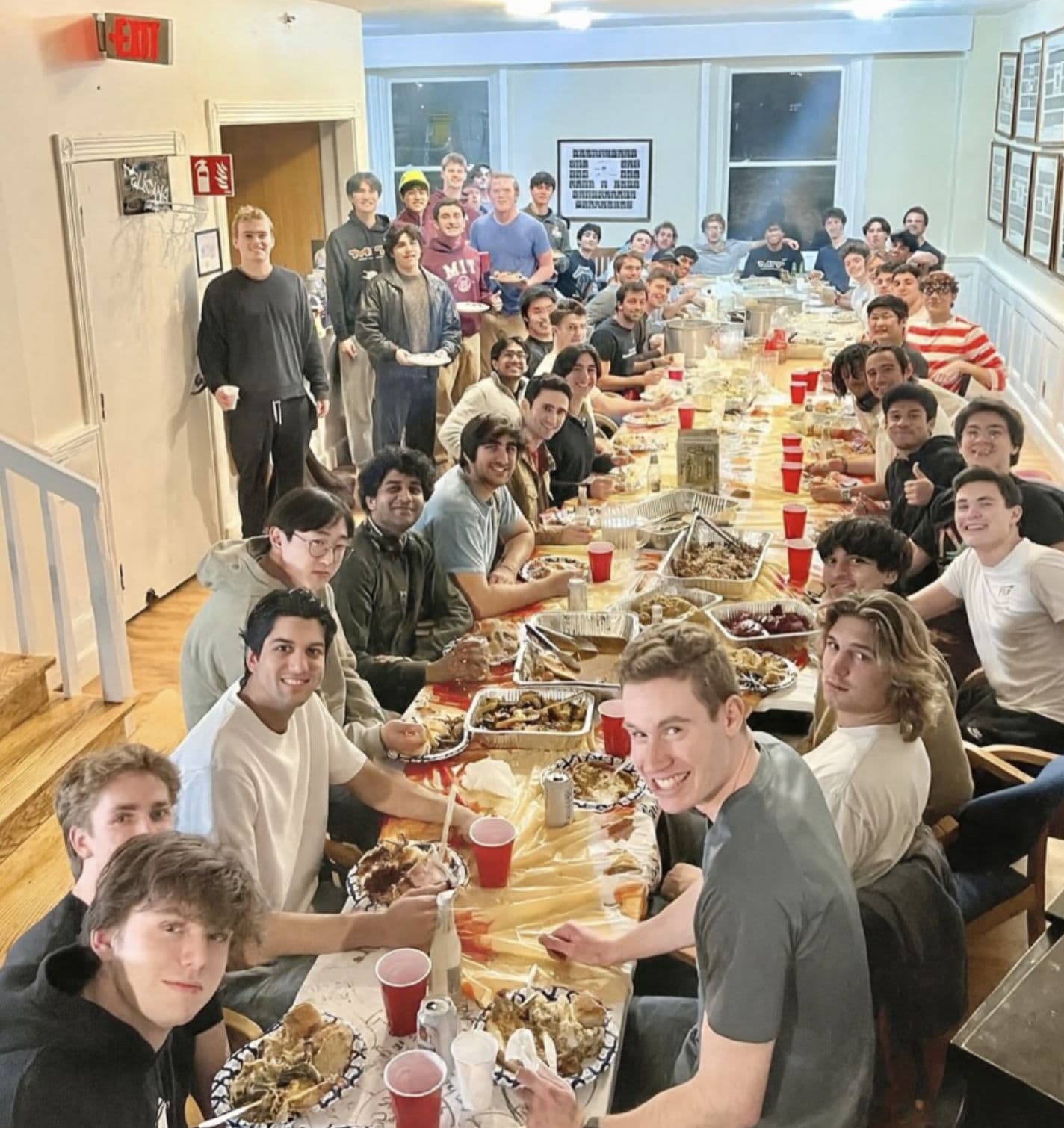 The whole house crowded around the long dining table for house dinner.