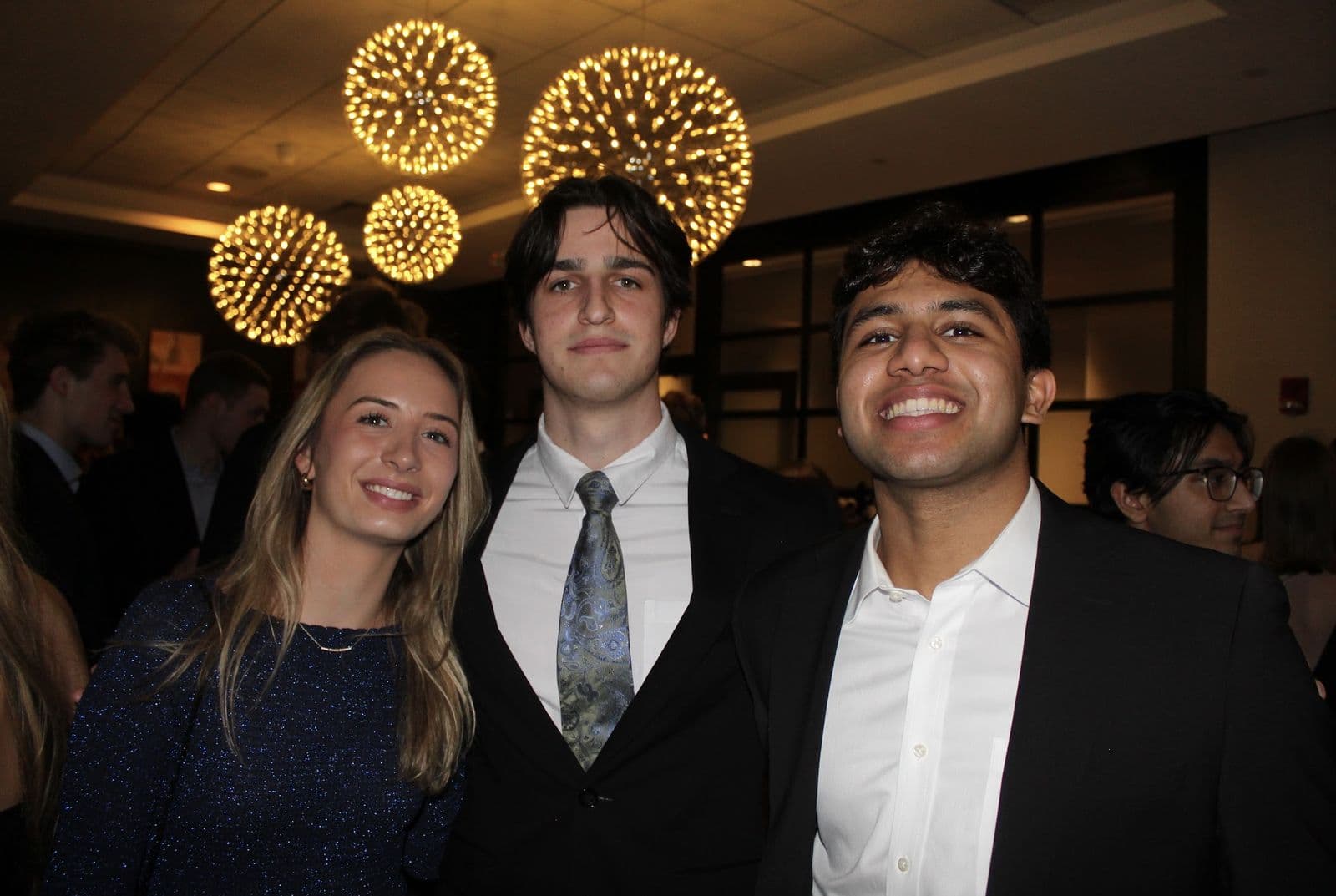 Brothers and dates at Fall Formal under the ballroom lights.