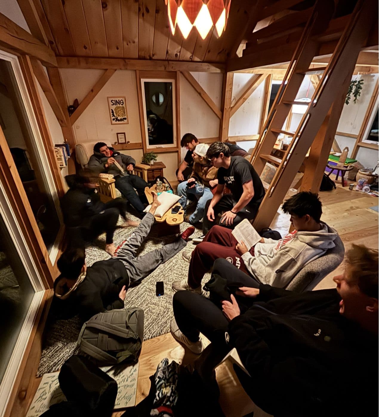 Brothers spread out across the floor of a timber-frame lodge.