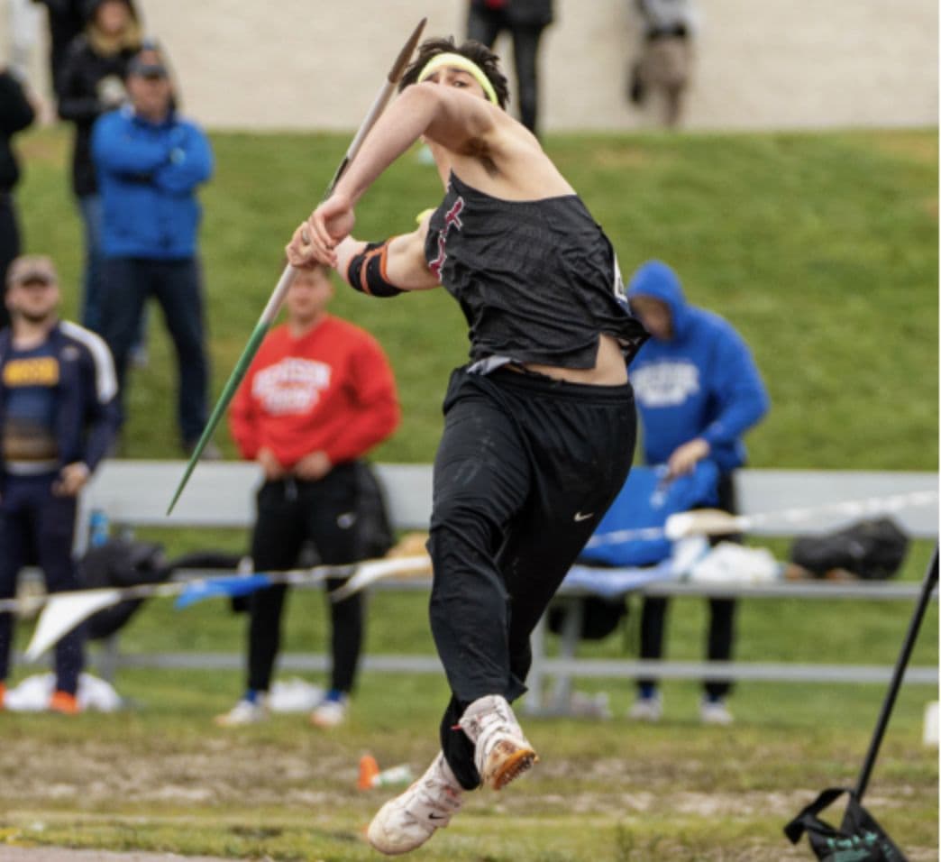 An MIT athlete mid-throw in the javelin.